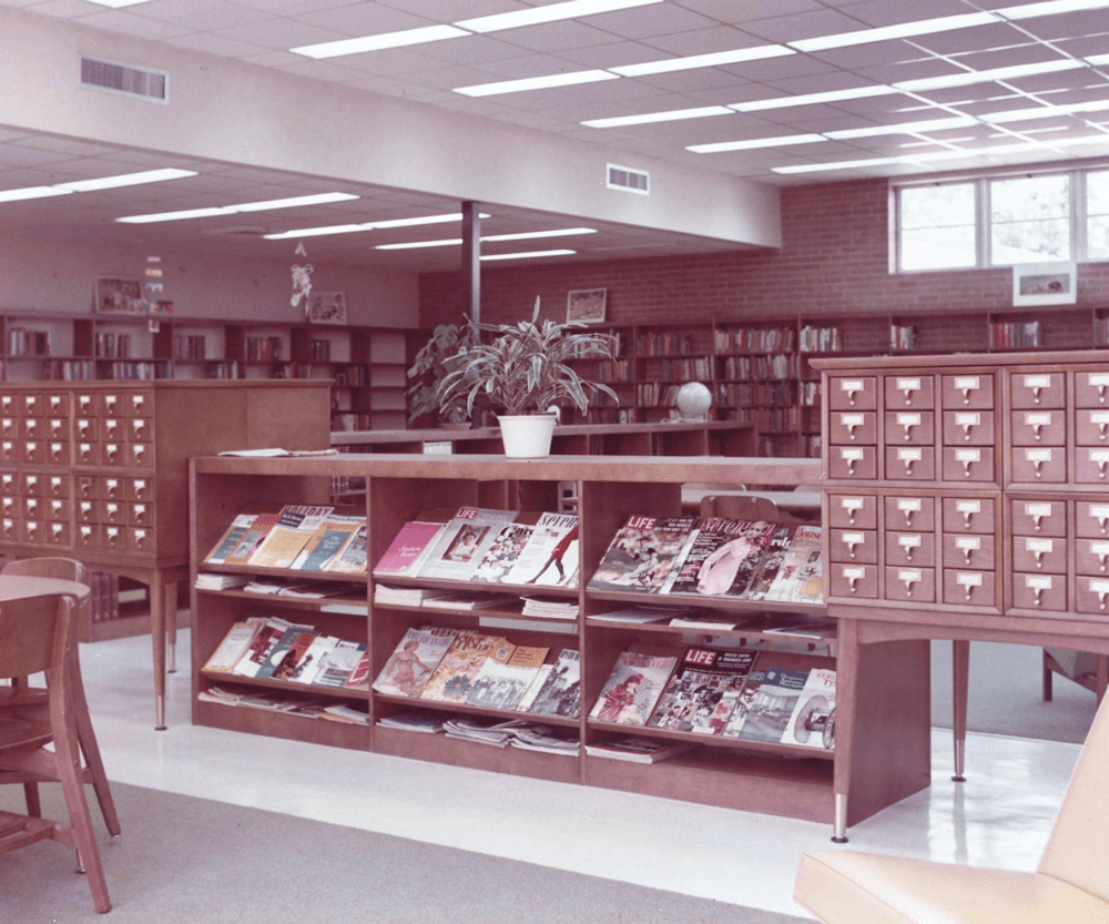 A plant on top of a magazine display at Pointe Coupee Parish Library circa 1961.
