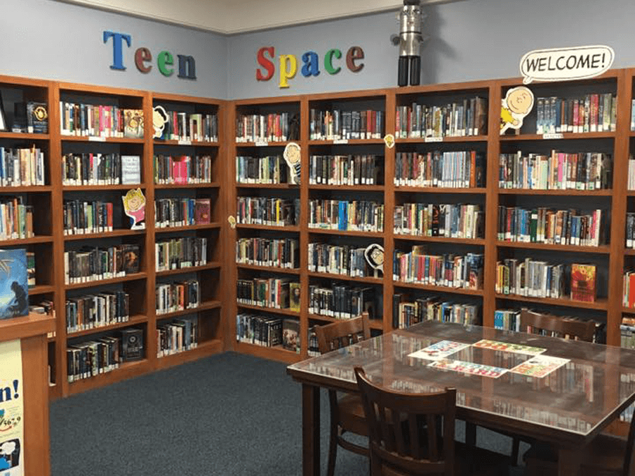 The teen space of the Innis Library branch has cutouts of Charlie Brown characters on the bookshelves.