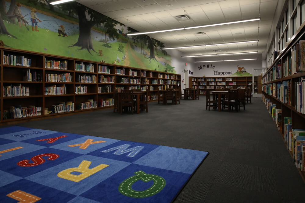 Livonia public library's children's area includes a playmat, desks, and plenty of books to take from the shelves.