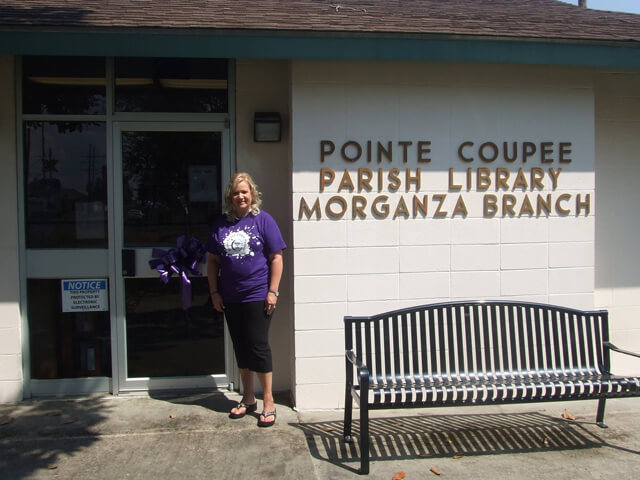 Morganza library branch manager, Dana Bergeron, standing outside branch entrance.