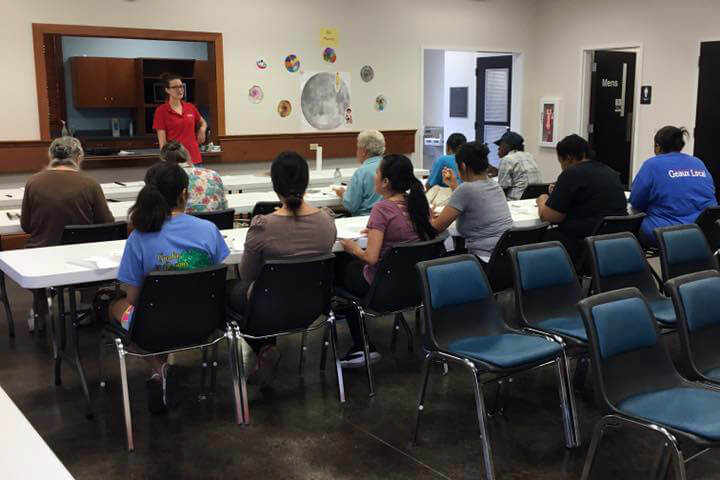 A speaker talking to a group of people in a Pointe Coupee Library meeting room in the Innis branch.