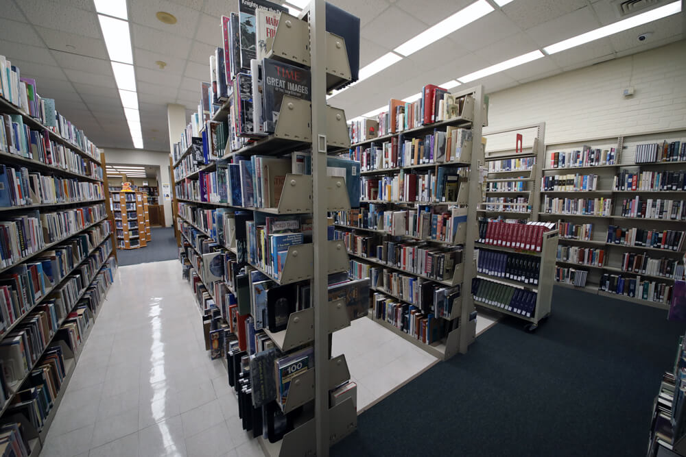 An extensive collection of books on metal bookshelves at Pointe Coupee Parish Library New Roads branch.
