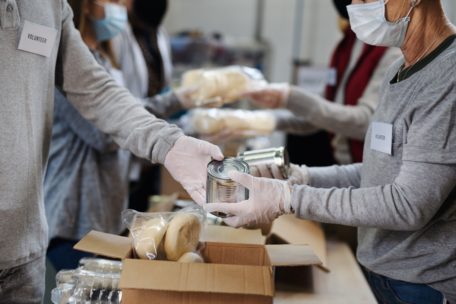 Food for Friends volunteers handle canned goods and other non-perishable items to be distributed by food pantries.